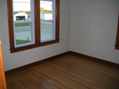 9428 Kleinman Road Highland, IN 46322 - Photo 6 of 10 a view of an empty room with wooden floor and a window