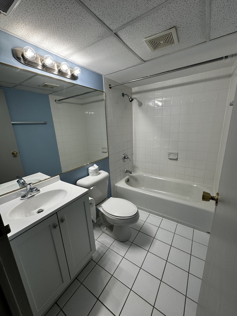 3220 Sanders Road, Unit 1A Northbrook, IL 60062 - Photo 7 of 8 a bathroom with a toilet a sink and shower