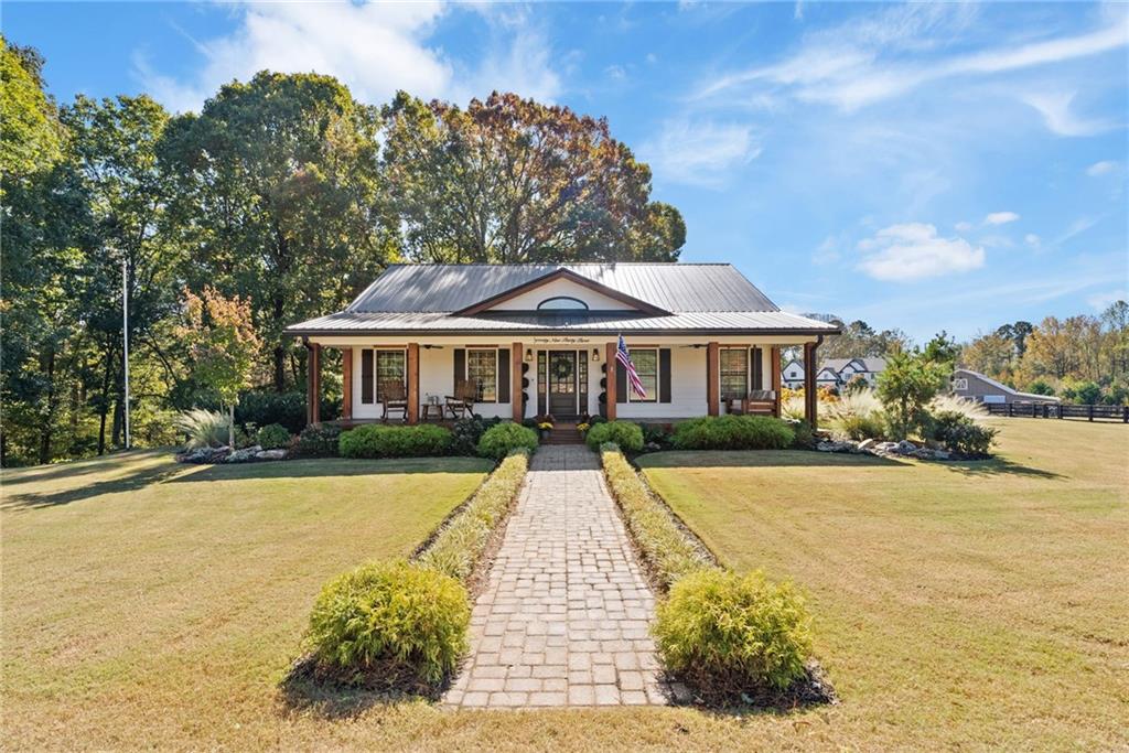 7933 Midway Road Alpharetta, GA 30004 - Photo 16 of 101 a front view of house with yard and lake view