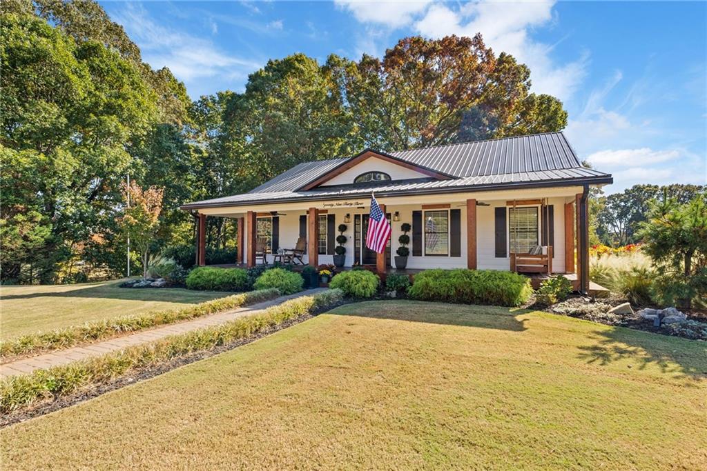 7933 Midway Road Alpharetta, GA 30004 - Photo 18 of 101 a front view of a house with a garden