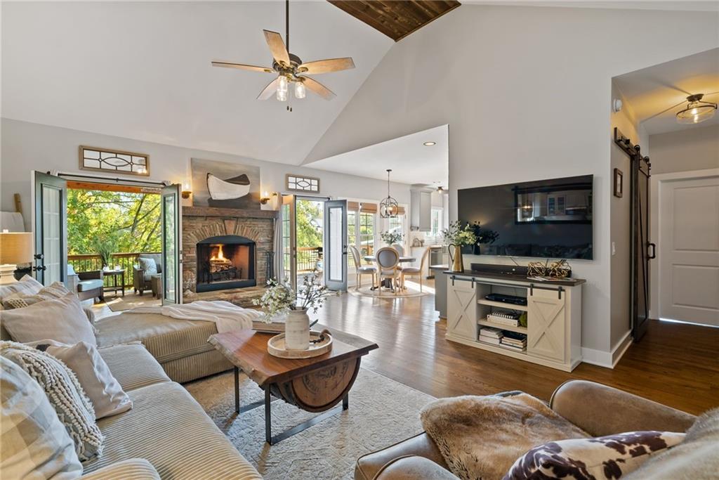 7933 Midway Road Alpharetta, GA 30004 - Photo 29 of 101 a living room with furniture a fireplace and a flat screen tv