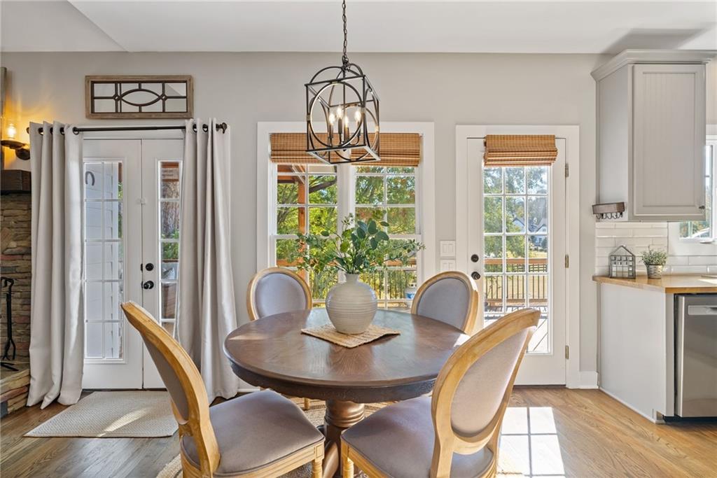 7933 Midway Road Alpharetta, GA 30004 - Photo 33 of 101 a dining room with furniture a chandelier and wooden floor