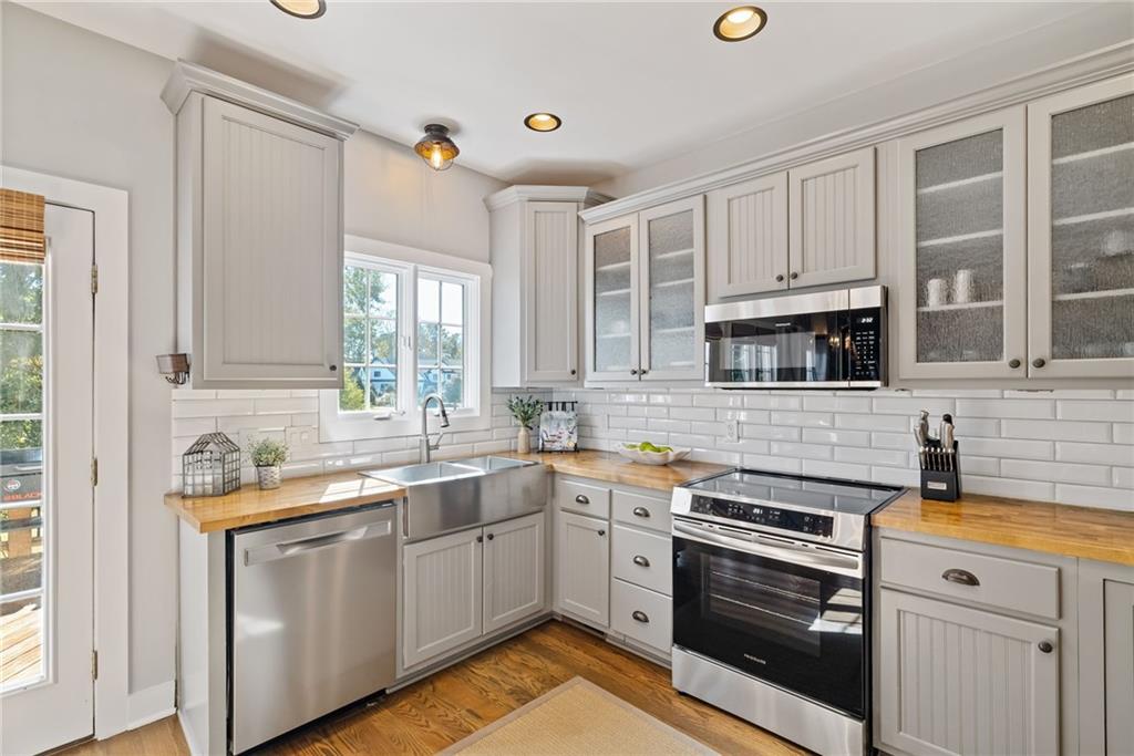 7933 Midway Road Alpharetta, GA 30004 - Photo 38 of 101 a kitchen with stainless steel appliances white cabinets and a sink