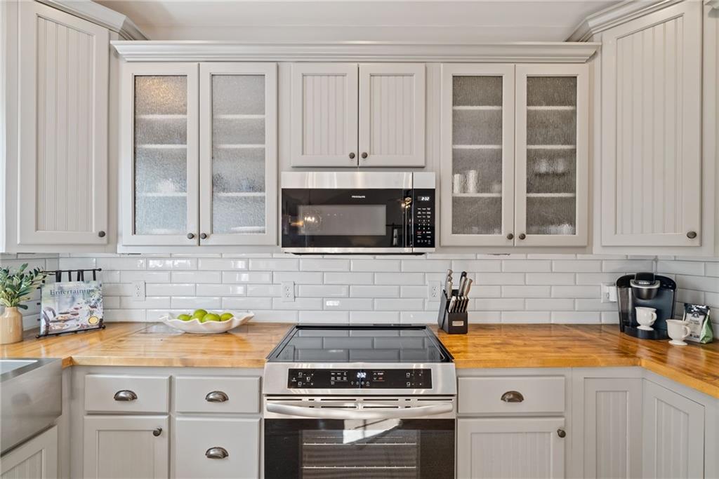 7933 Midway Road Alpharetta, GA 30004 - Photo 40 of 101 a kitchen with granite countertop a stove sink and cabinets
