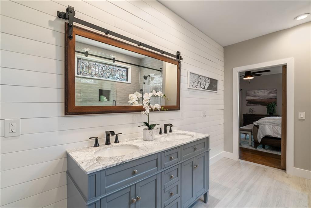 7933 Midway Road Alpharetta, GA 30004 - Photo 50 of 101 a en suite bathroom with a granite countertop sink and a mirror