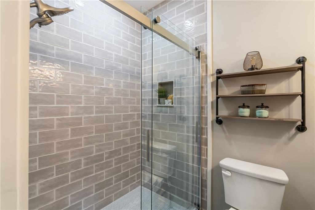 7933 Midway Road Alpharetta, GA 30004 - Photo 57 of 101 a bathroom with a toilet and a shower