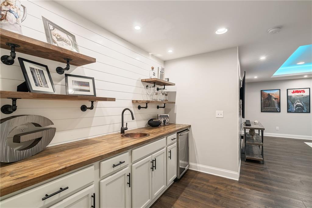 7933 Midway Road Alpharetta, GA 30004 - Photo 62 of 101 a kitchen with stainless steel appliances granite countertop a sink stove and cabinets