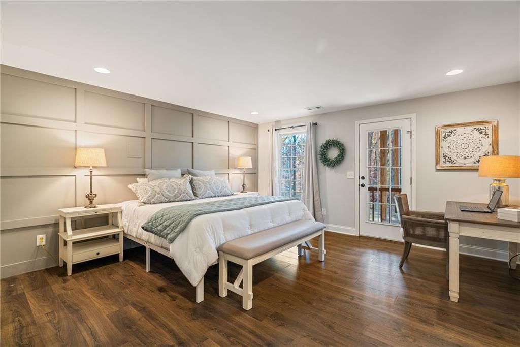 7933 Midway Road Alpharetta, GA 30004 - Photo 65 of 101 a spacious bedroom with a bed and a table in it