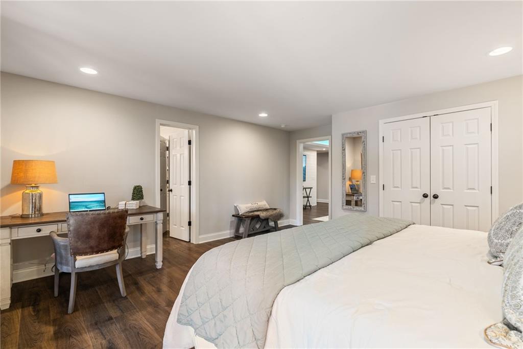 7933 Midway Road Alpharetta, GA 30004 - Photo 67 of 101 a bedroom with a bed and wooden floor