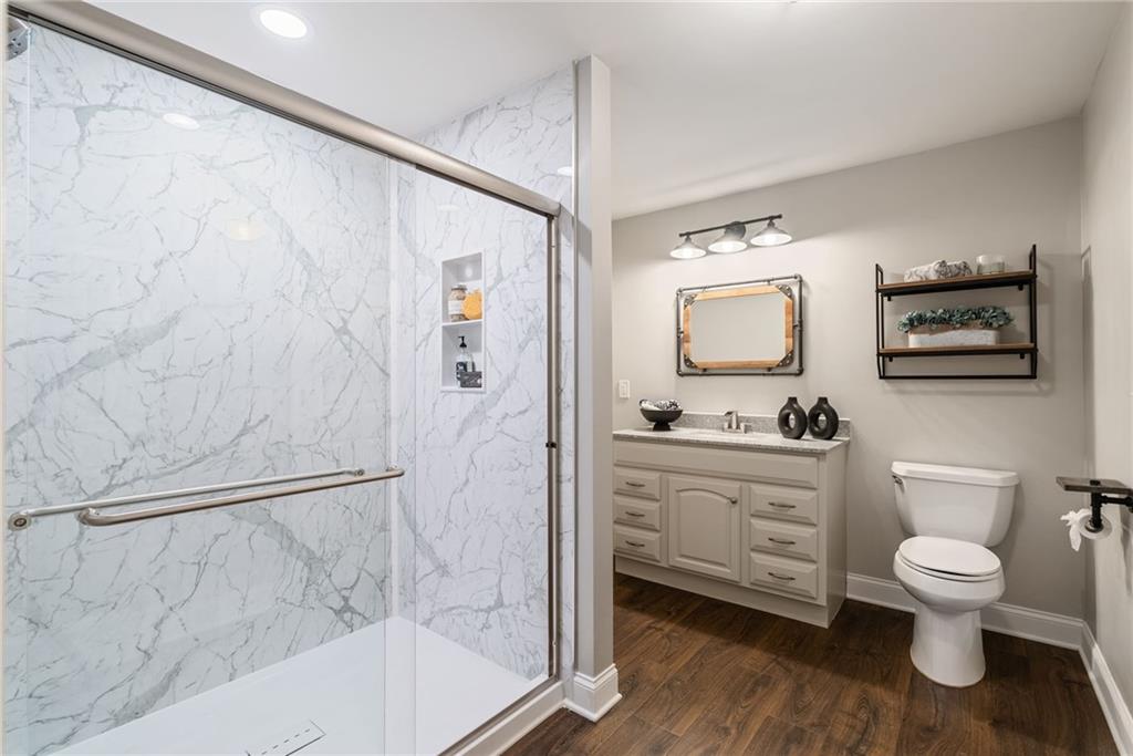 7933 Midway Road Alpharetta, GA 30004 - Photo 68 of 101 a bathroom with a granite countertop sink toilet and shower