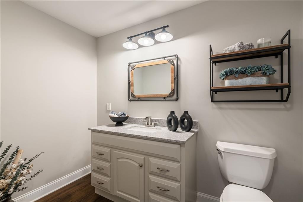 7933 Midway Road Alpharetta, GA 30004 - Photo 70 of 101 a bathroom with a toilet sink and mirror
