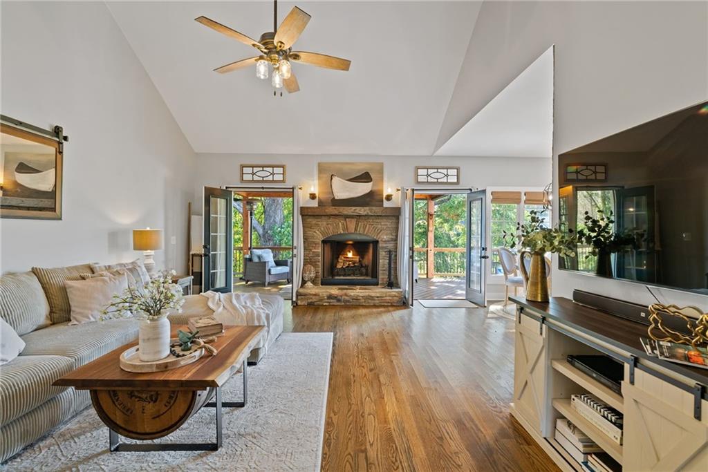 7933 Midway Road Alpharetta, GA 30004 - Photo 7 of 101 a living room with furniture a fireplace and a floor to ceiling window