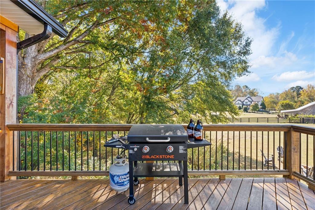 7933 Midway Road Alpharetta, GA 30004 - Photo 77 of 101 a view of a deck with furniture and wooden floor