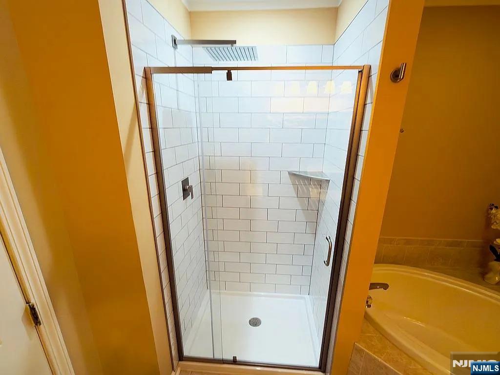 136 Mountainside Drive Pompton Lakes, NJ 07442 - Photo 23 of 36 a bathroom with a tub and a shower