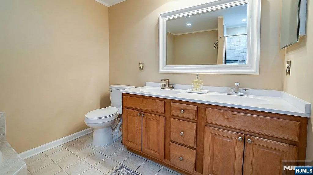 136 Mountainside Drive Pompton Lakes, NJ 07442 - Photo 24 of 36 a bathroom with a toilet sink and mirror