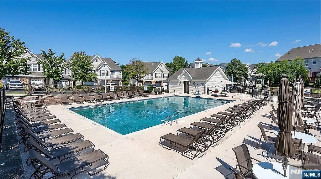 136 Mountainside Drive Pompton Lakes, NJ 07442 - Photo 33 of 36 a view of a swimming pool with a terrace and seating area