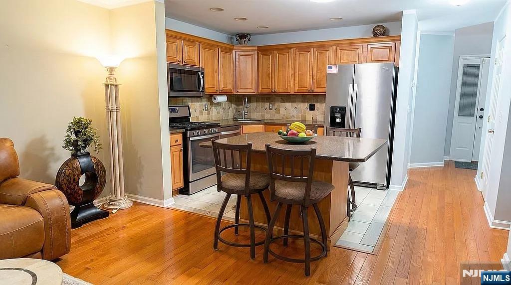 136 Mountainside Drive Pompton Lakes, NJ 07442 - Photo 10 of 36 a kitchen with stainless steel appliances a refrigerator a stove a sink dishwasher and a microwave