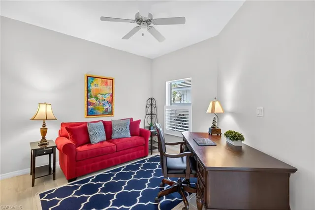a living room with furniture and a lamp