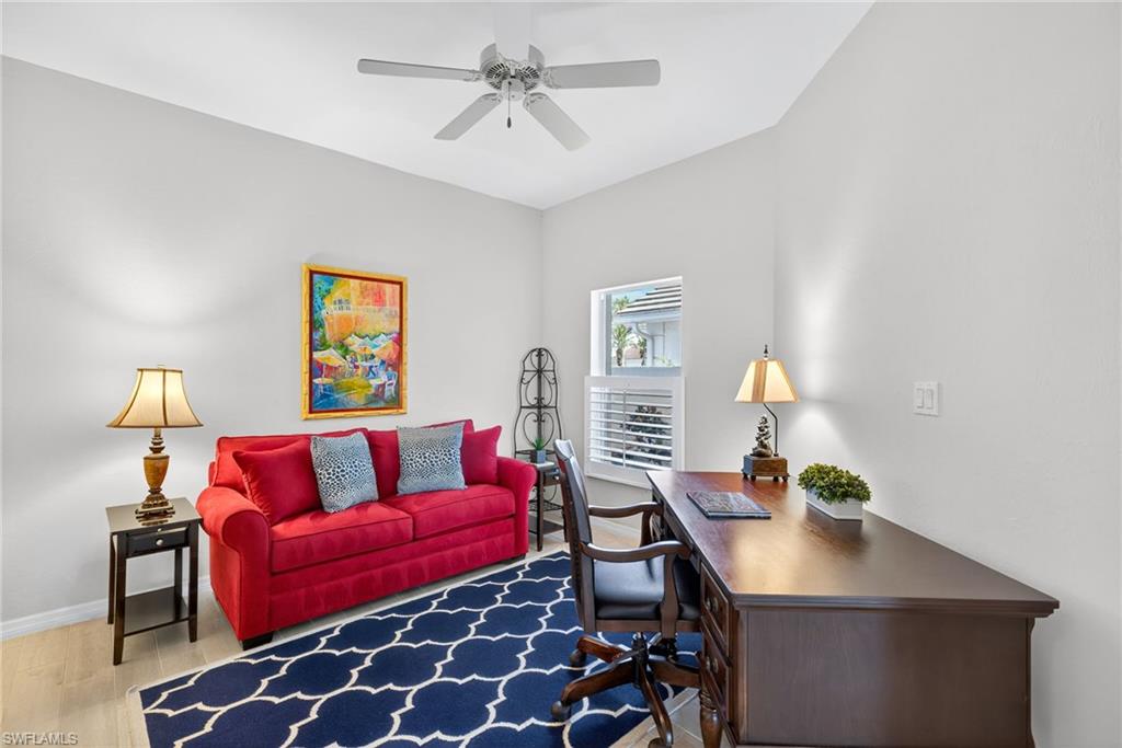 2193 Paget Circle, Unit 1 25 Naples, FL 34112 - Photo 14 of 50 a living room with furniture and a lamp