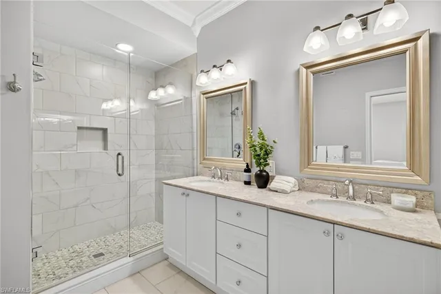a bathroom with a granite countertop sink mirror and shower