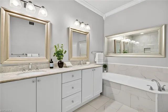a bathroom with a granite countertop sink mirror and bathtub
