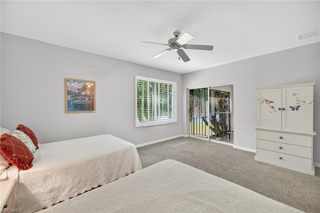 2193 Paget Circle, Unit 1 25 Naples, FL 34112 - Photo 23 of 50 a bedroom with a large bed and a window