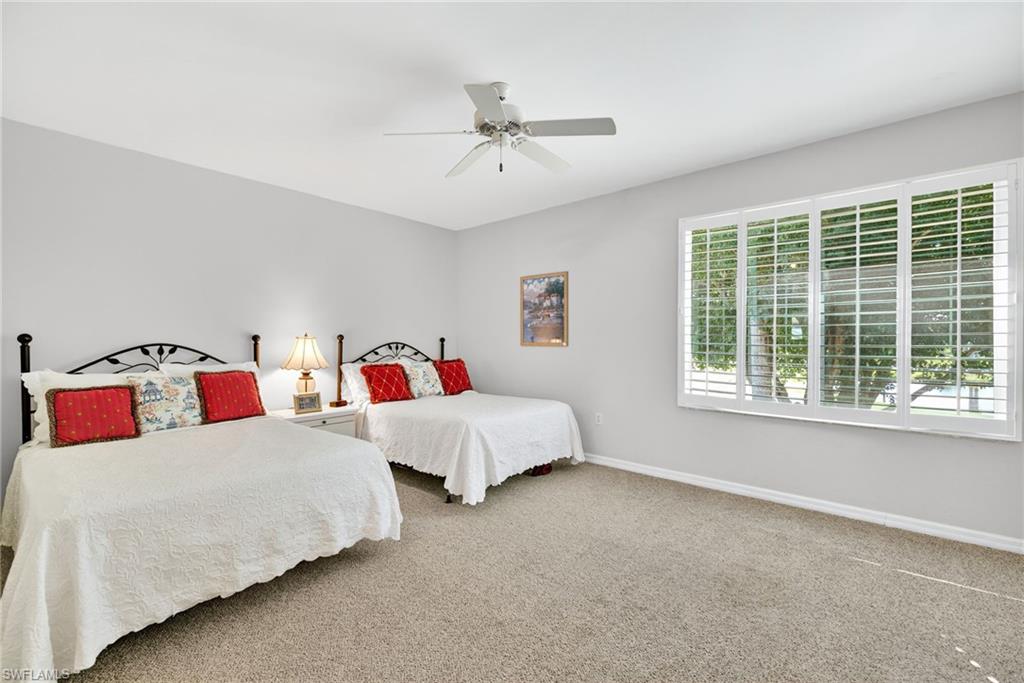 2193 Paget Circle, Unit 1 25 Naples, FL 34112 - Photo 24 of 50 a bedroom with bed and a large window