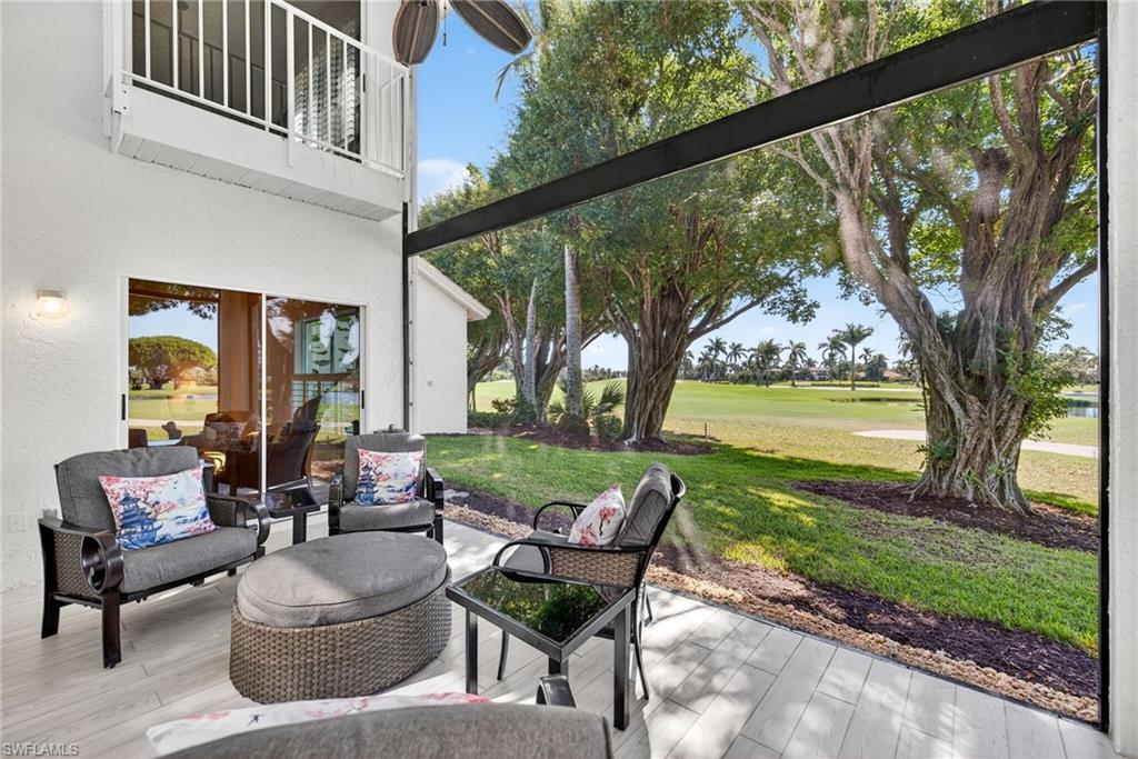 2193 Paget Circle, Unit 1 25 Naples, FL 34112 - Photo 28 of 50 a patio view with patio couches and a table