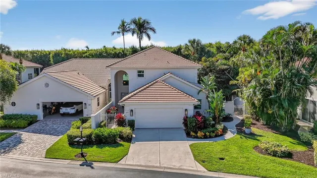 an aerial view of a house with a garden and lake view