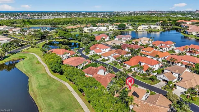 an aerial view of lake and residential houses with outdoor space