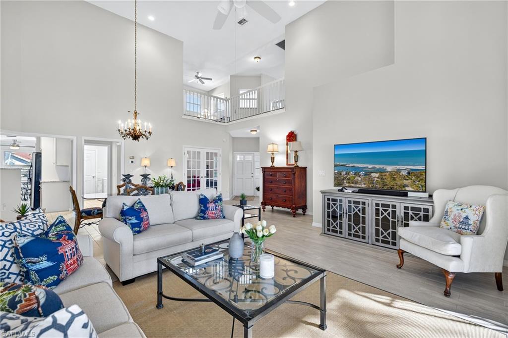 2193 Paget Circle, Unit 1 25 Naples, FL 34112 - Photo 5 of 50 a living room with furniture a rug and a chandelier