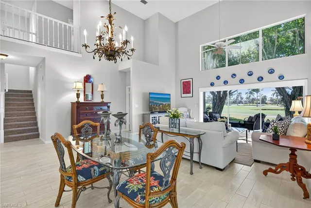 a view of a dining room with furniture a chandelier and wooden floor