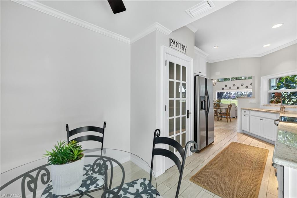 2193 Paget Circle, Unit 1 25 Naples, FL 34112 - Photo 10 of 50 a bedroom with furniture and a potted plant