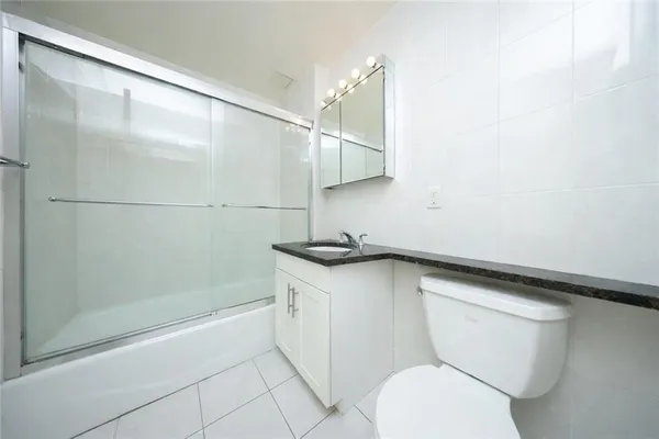 a bathroom with a sink a toilet and a shower