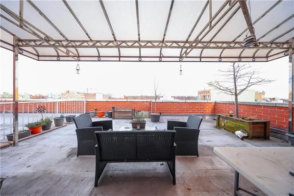 a terrace with outdoor seating and city view