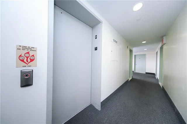 a view of a hallway with wooden shelves