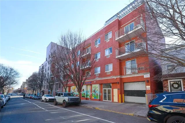 a view of a cars parked on the side of a street