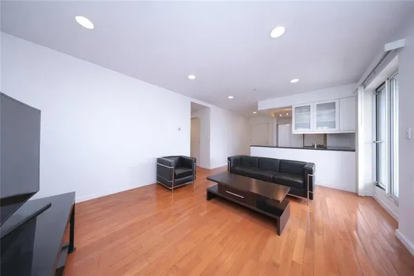 a living room with furniture and a wooden floor