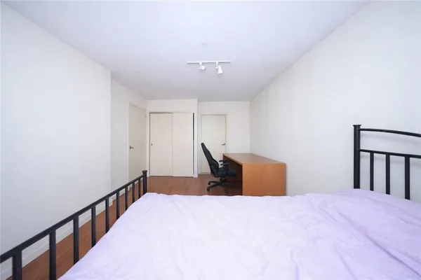 a bedroom with a bed and chair