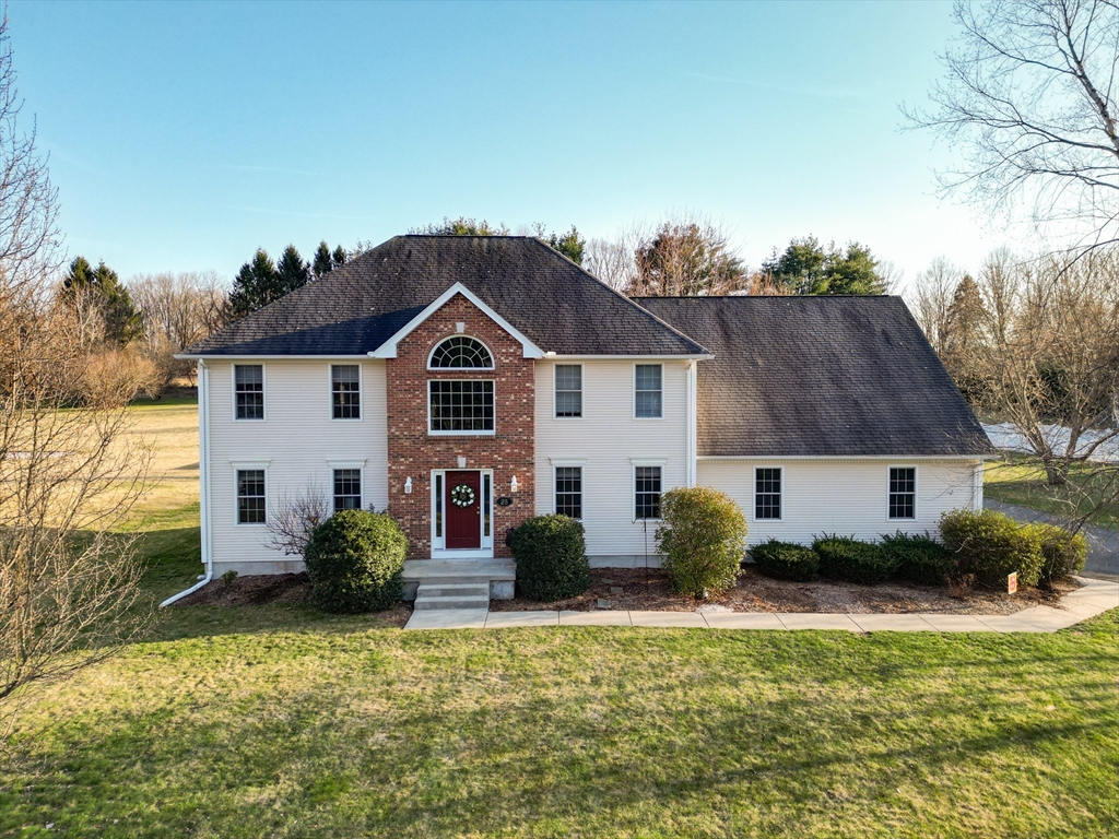 25 Mill Road East Longmeadow, MA 01028 - Photo 1 of 38 a front view of a house with a yard and garage
