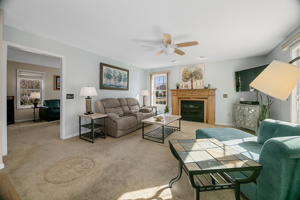 25 Mill Road East Longmeadow, MA 01028 - Photo 12 of 38 a living room with furniture a fireplace and a flat screen tv