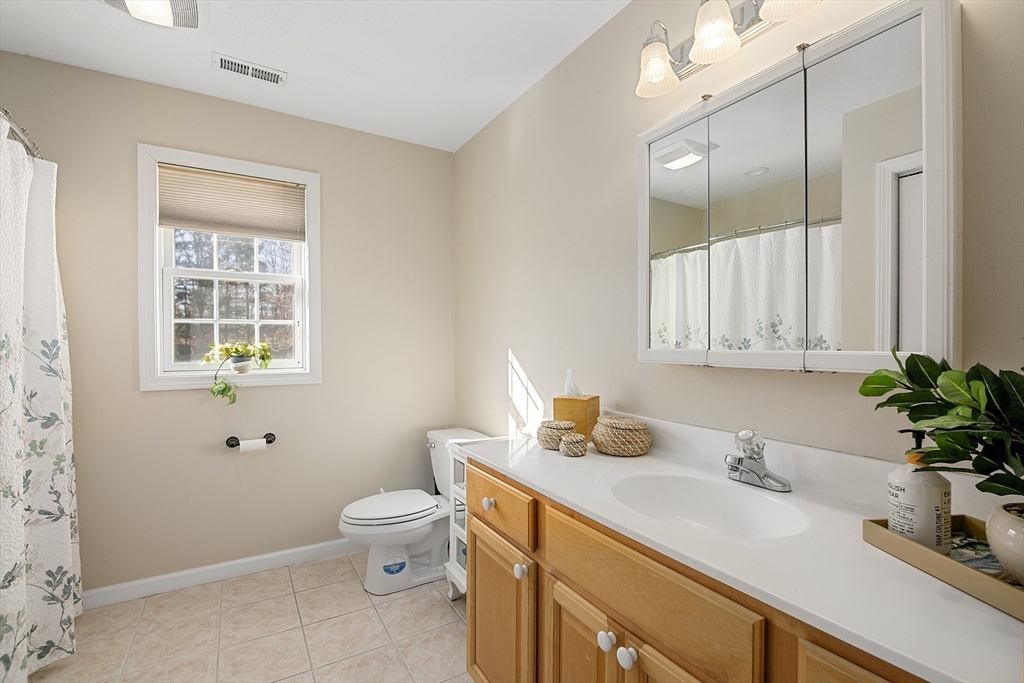 25 Mill Road East Longmeadow, MA 01028 - Photo 28 of 38 a bathroom with a sink a toilet and a mirror