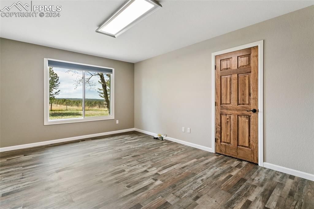 12990 Mc Cune Road Elbert, CO 80106 - Photo 17 of 50 wooden floor in an empty room with a window
