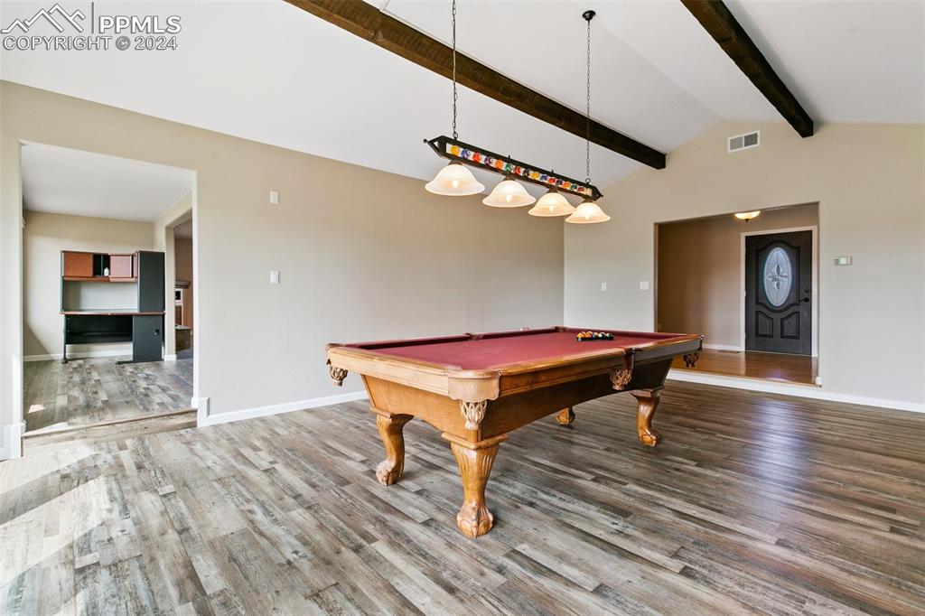 12990 Mc Cune Road Elbert, CO 80106 - Photo 19 of 50 a room with wooden floor and pool table