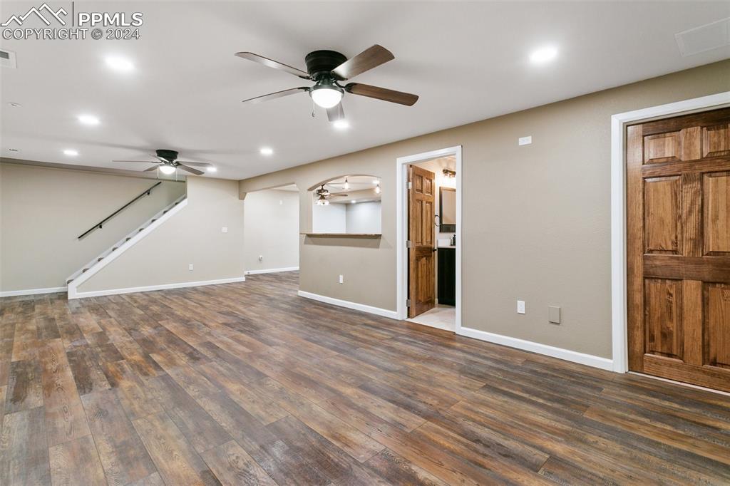 12990 Mc Cune Road Elbert, CO 80106 - Photo 32 of 50 an empty room with wooden floor and a ceiling fan
