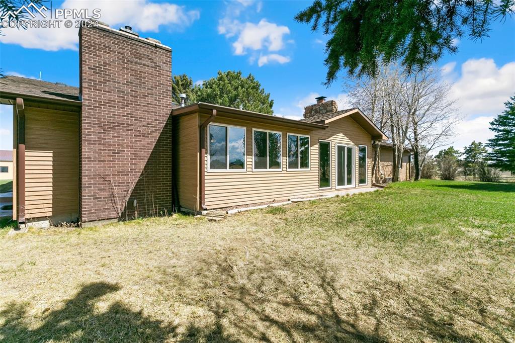 12990 Mc Cune Road Elbert, CO 80106 - Photo 48 of 50 a front view of a house with a garden