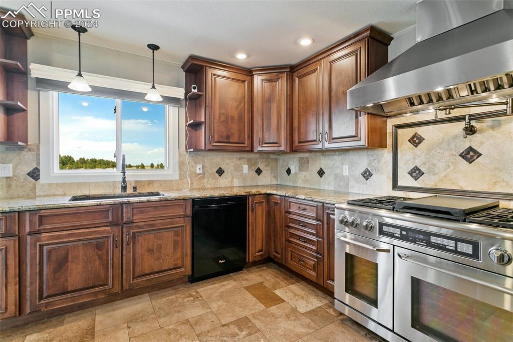 12990 Mc Cune Road Elbert, CO 80106 - Photo 7 of 50 a kitchen with stainless steel appliances granite countertop a stove a sink and a microwave