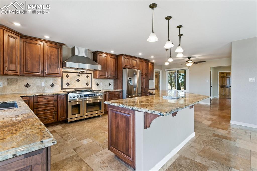 12990 Mc Cune Road Elbert, CO 80106 - Photo 8 of 50 a kitchen with stainless steel appliances granite countertop a stove oven and a refrigerator with cabinets