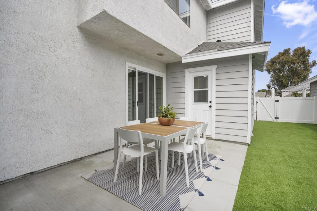 803 Skysail Avenue Carlsbad, CA 92011 - Photo 13 of 15 a backyard of a house with table and chairs