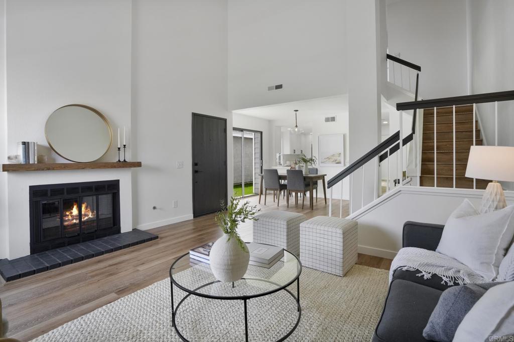 803 Skysail Avenue Carlsbad, CA 92011 - Photo 3 of 15 a living room with furniture and a fireplace